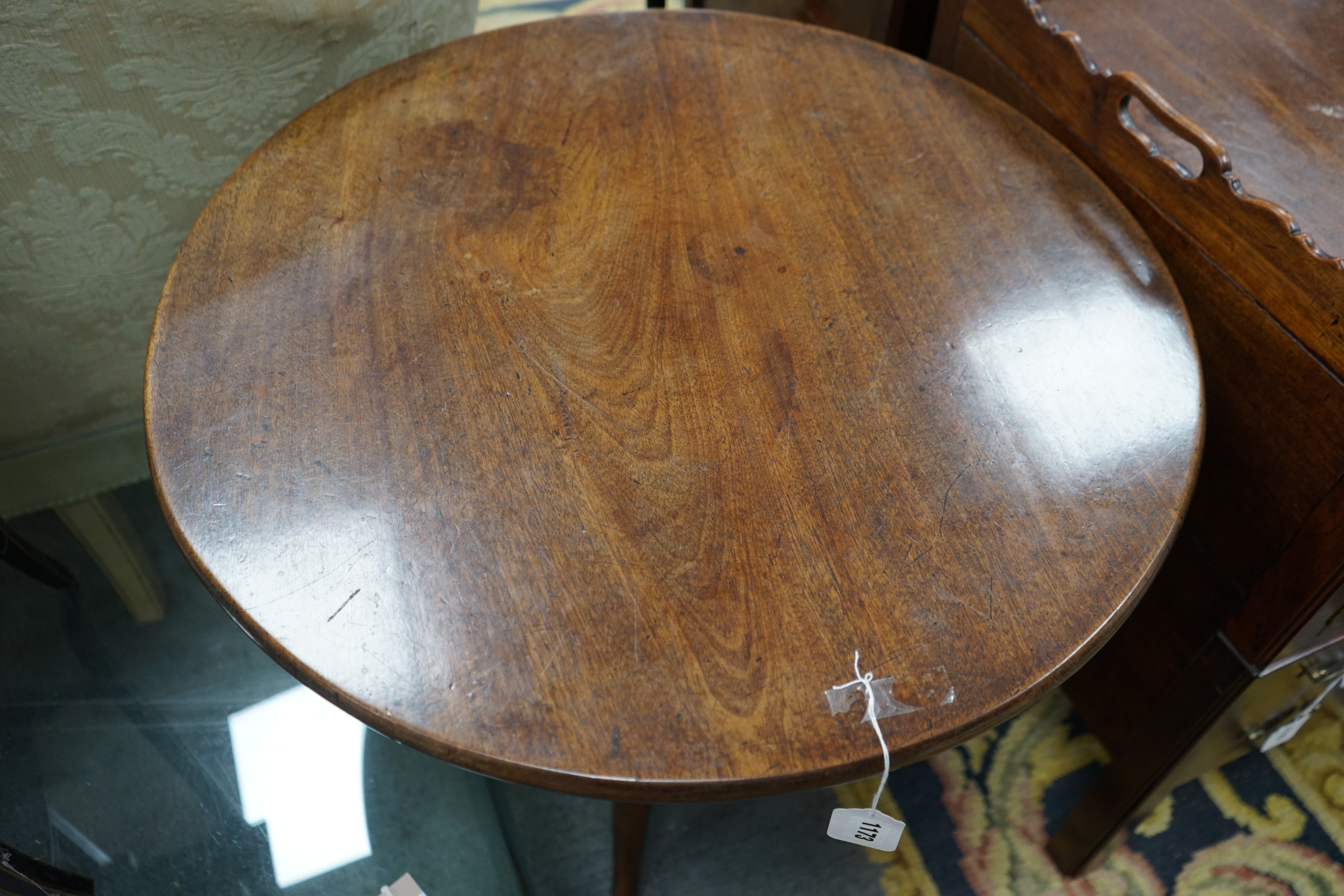 A George III circular mahogany tilt top tripod tea table, diameter 65cm, height 72cm